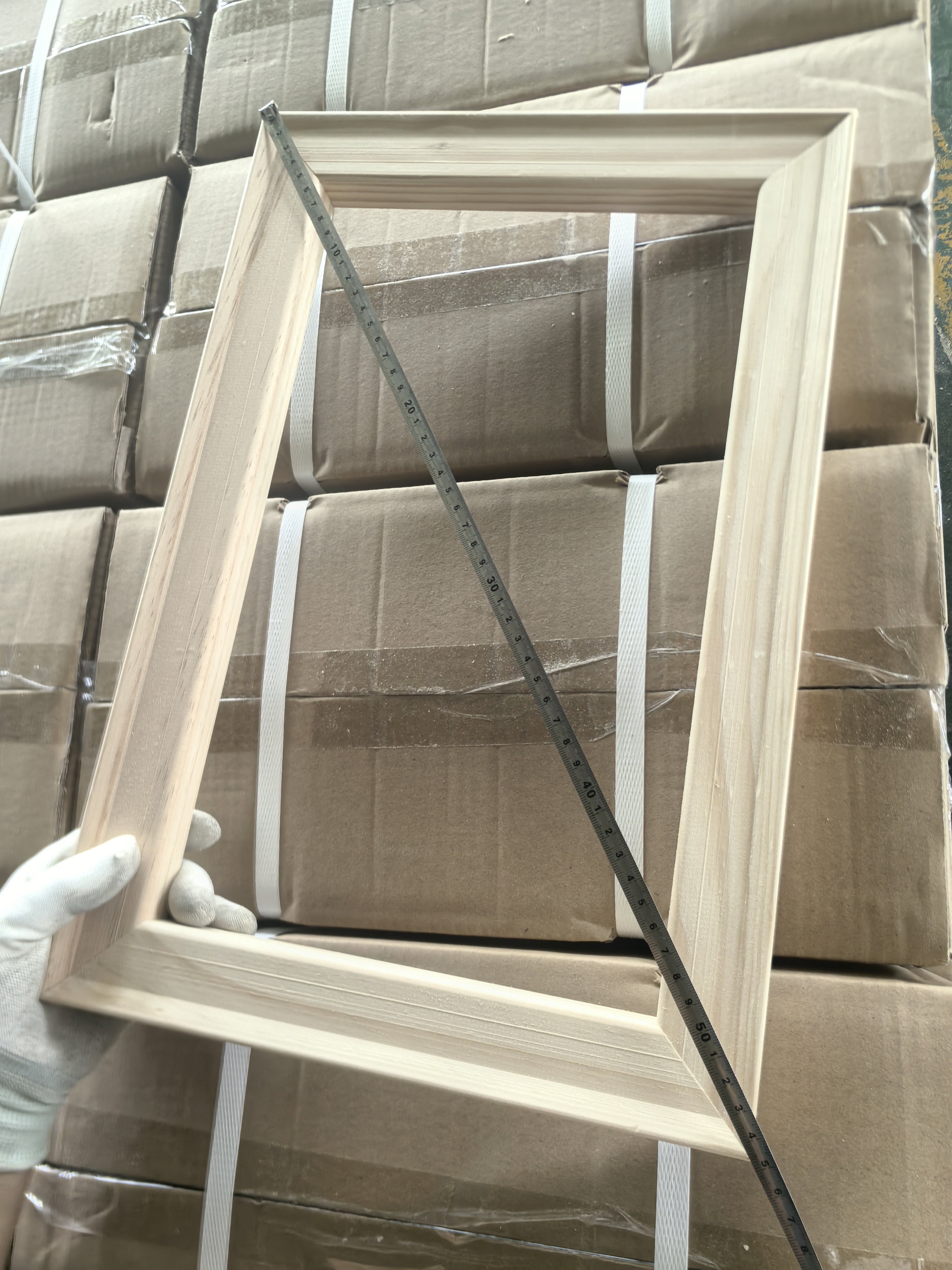 Diagonal measurement and squareness inspection of an assembled wooden canvas stretcher frame
