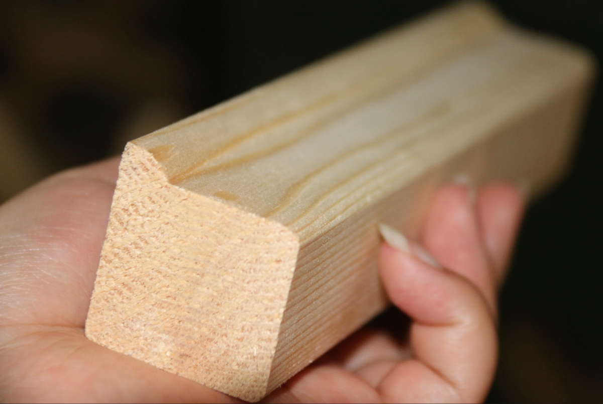 Close-up of pine wooden stretcher bar cross-section with rounded profile