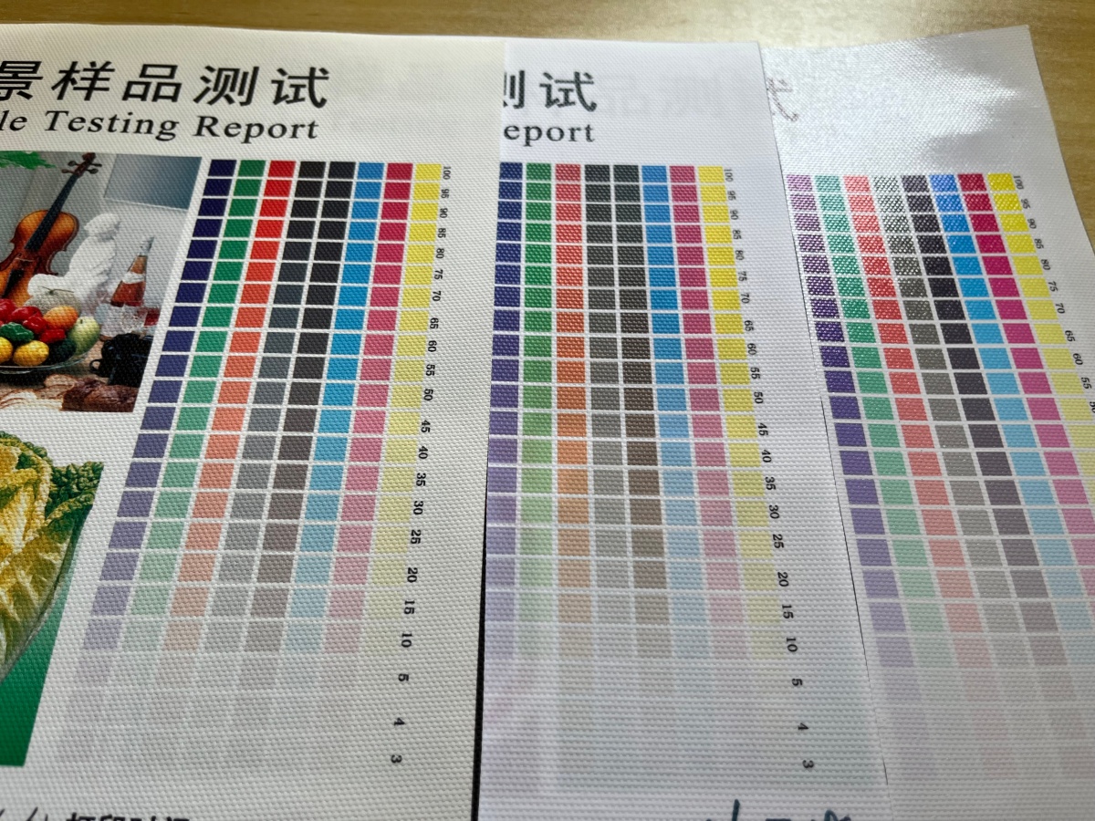 Printed canvas test charts with stepped color patches, gray tones and visible fabric texture